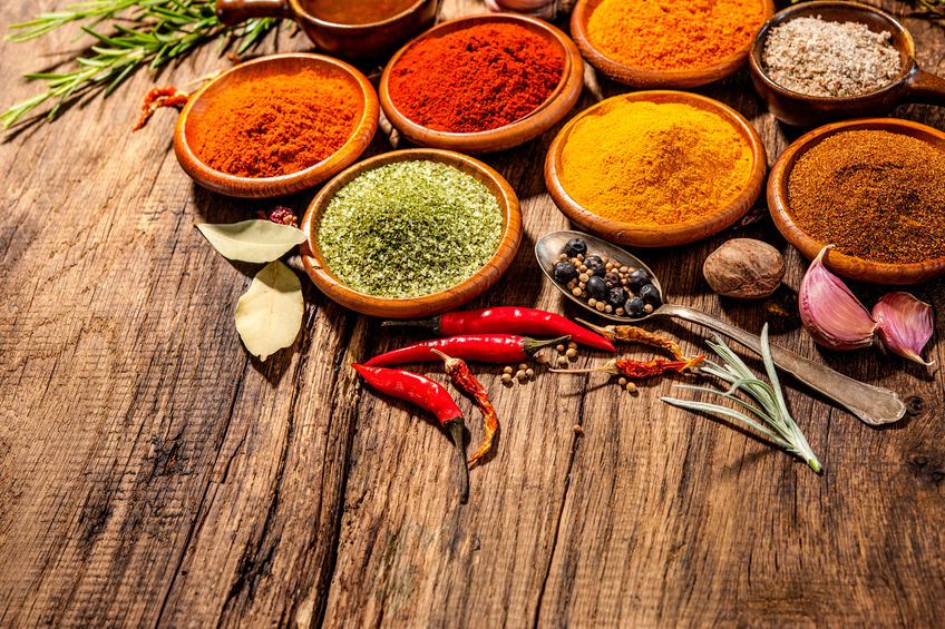 Various herbs and spices on wooden table